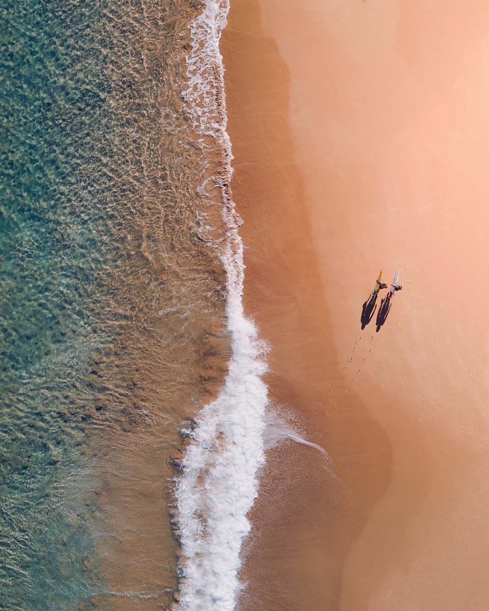 android wallpapers aerial photography of two persons walking along seashore during daytime android backgrounds